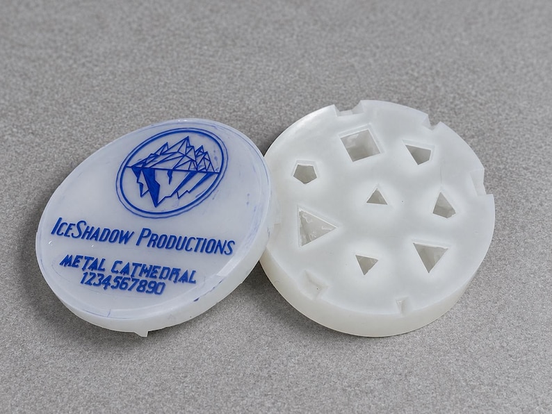Eight-cavity silicone dice mold with two D20 cavities and a matching Metal Cathedral lid