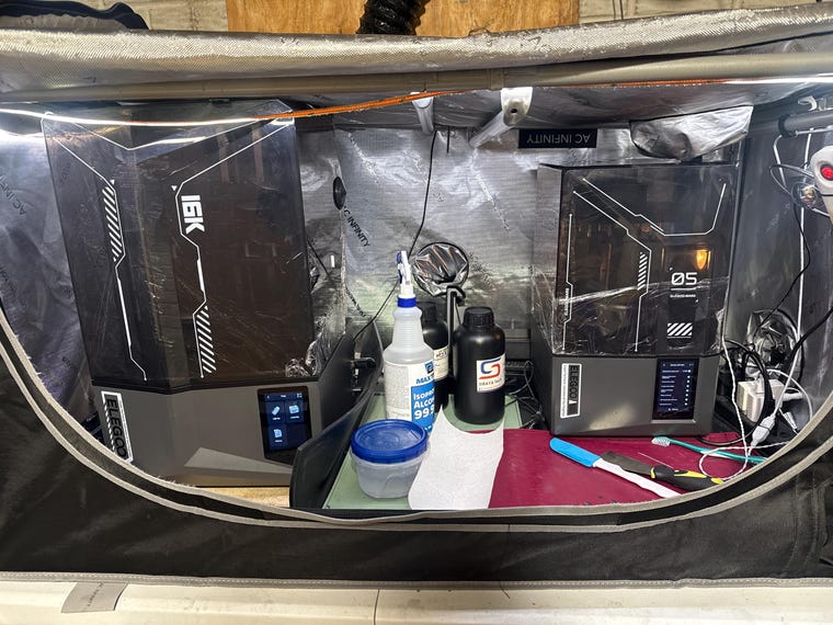 Two enclosed resin 3D printers and printing supplies in the IceShadow workspace